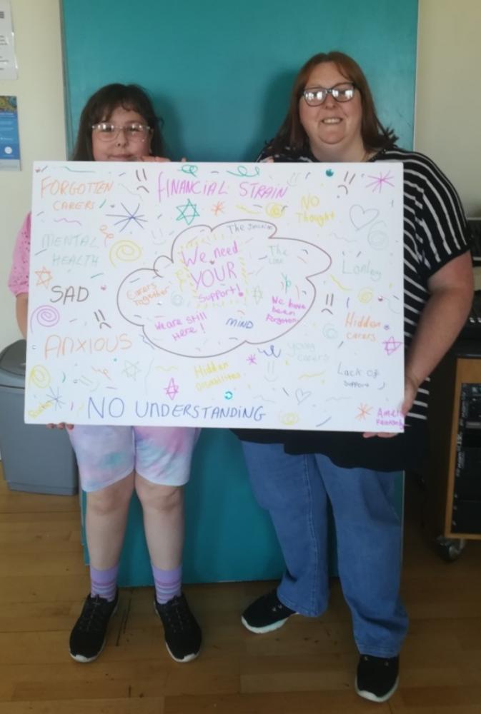 Young carer family with poster