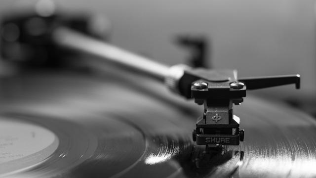 Black and white image of a record on a record player