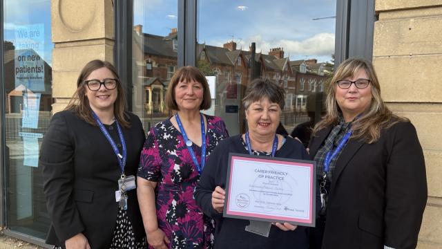 Staff at Newlands Medical Centre holding carer friendly certificate