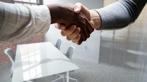 Shaking hands in office space