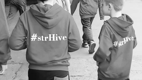 Children wearing branded StrHive jumpers